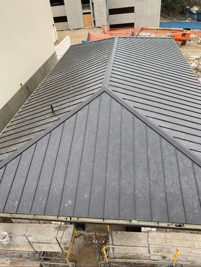 Commercial metal roof construction with crane equipment in Woodruff