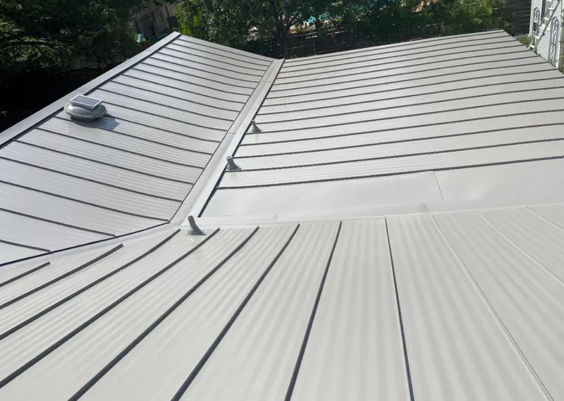 Solar attic fan installed on a metal roof for Roof Ventilation in Woodruff